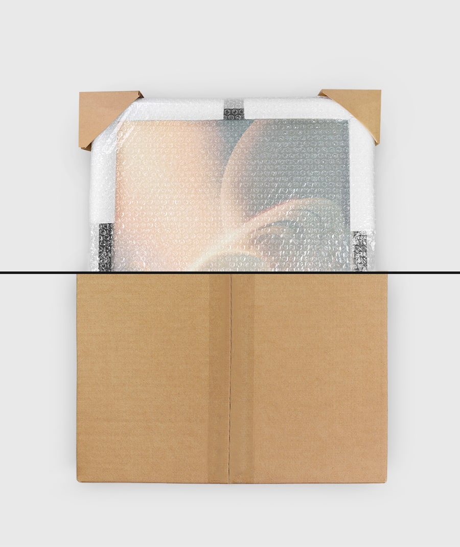 Cardboard box with bubble wrap and a clear plastic bag containing a product on a white background