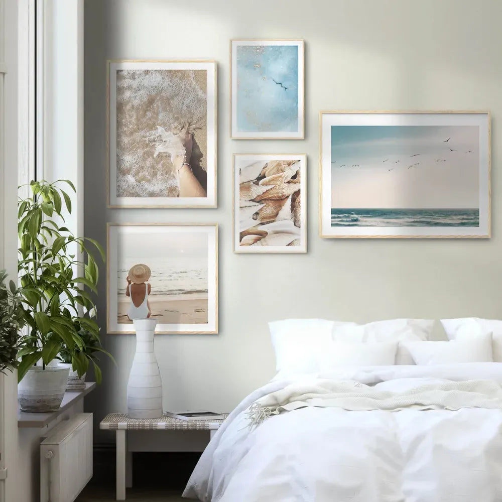 Bedroom with framed beach-themed artwork on the wall