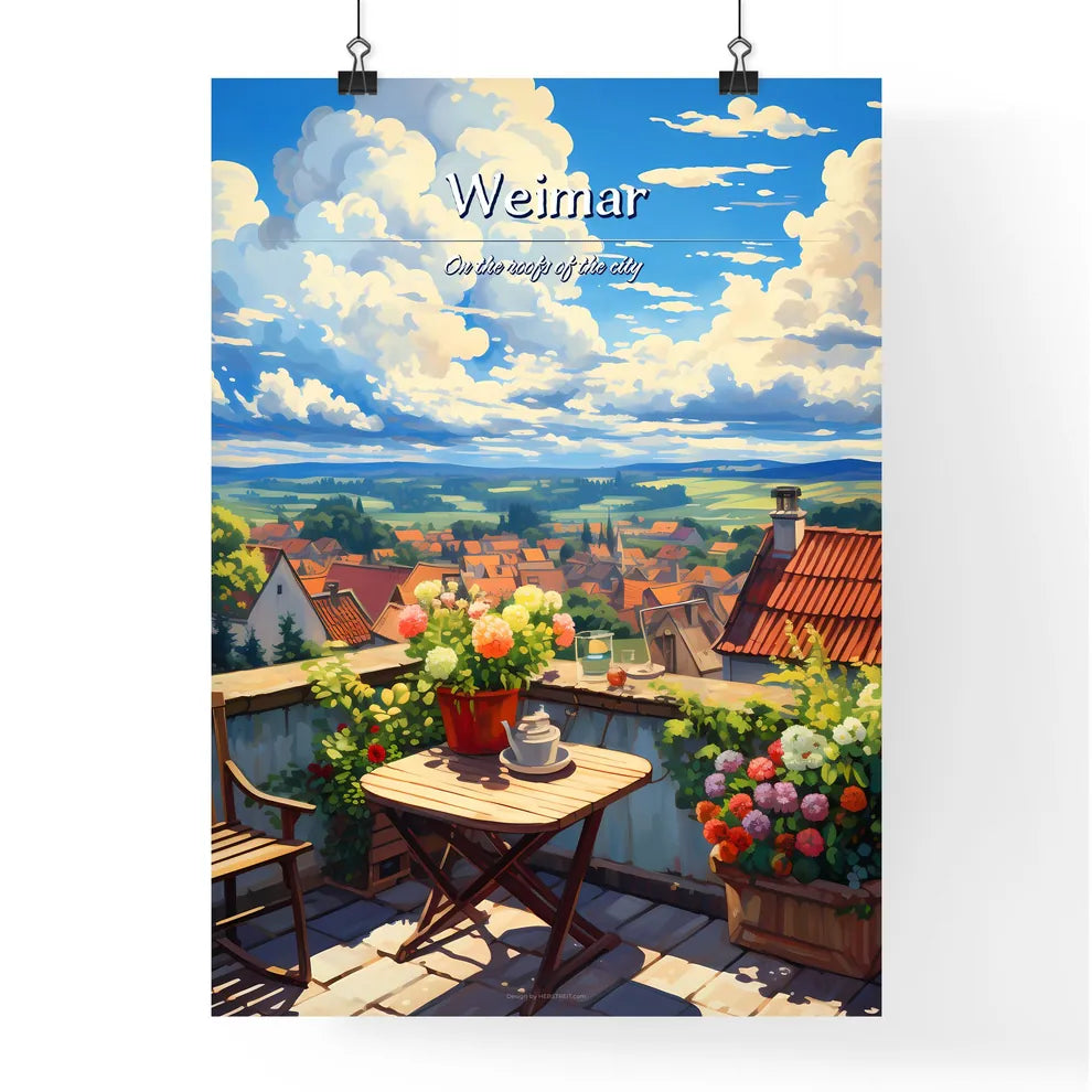 On the roofs of Weimar - Art print of a table and chairs on a balcony with a view of a town and a valley Poster