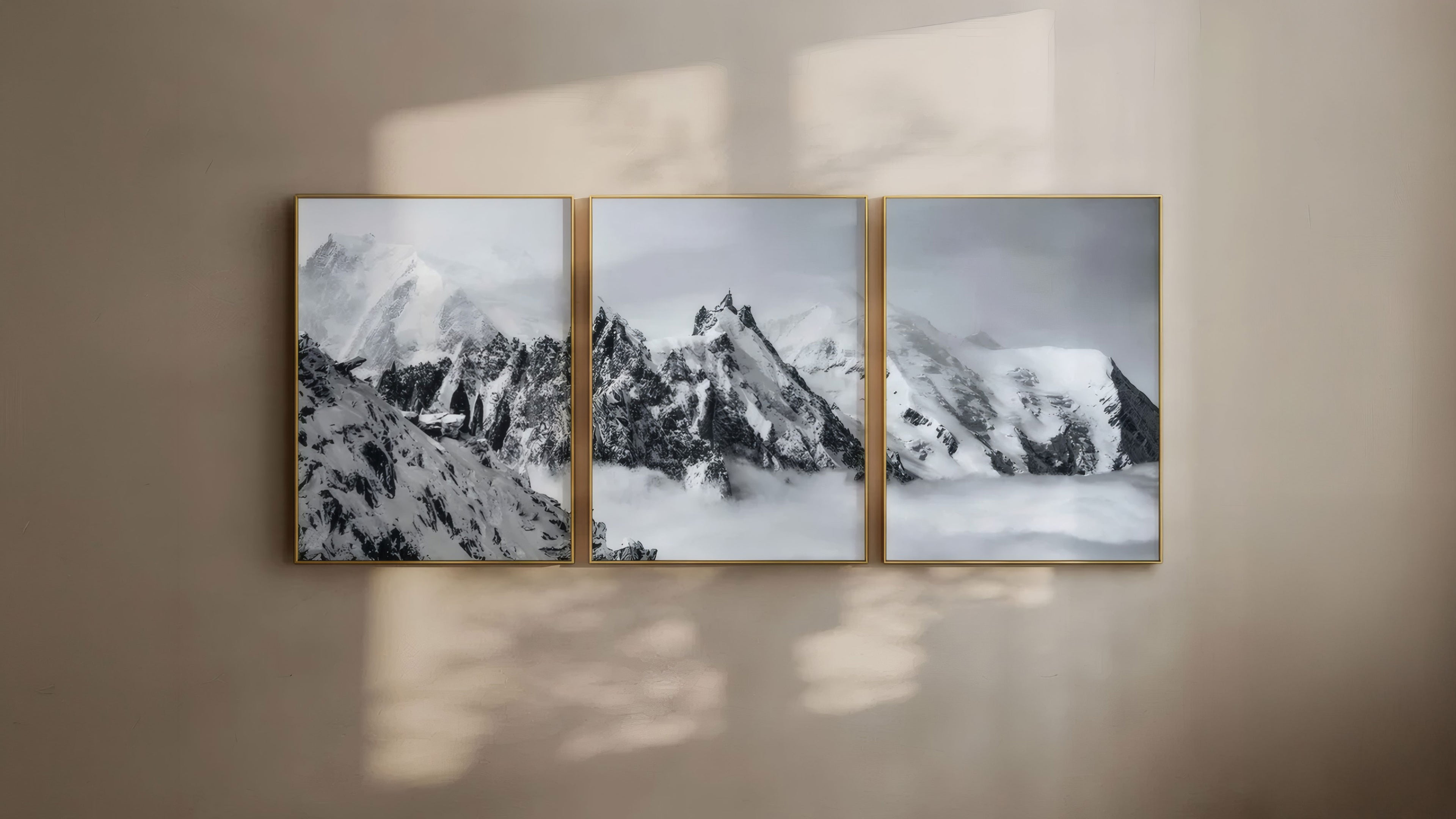 Triptych of mountain landscapes on a beige wall